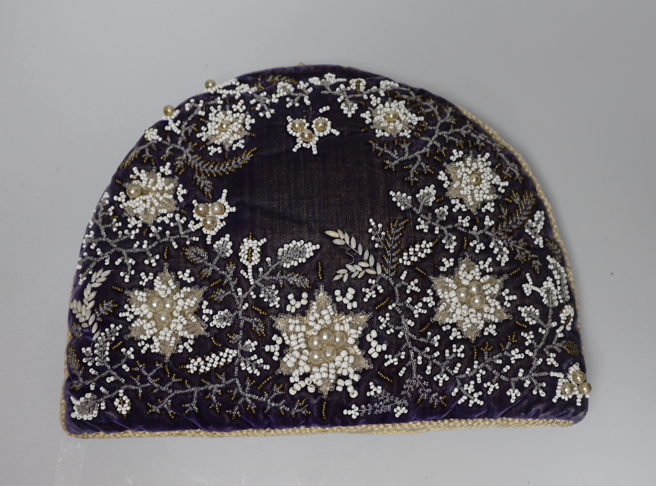 A Berlin-type late 19th century cushion and tea cosy with floral beadwork embroidery, the largest 35cm wide